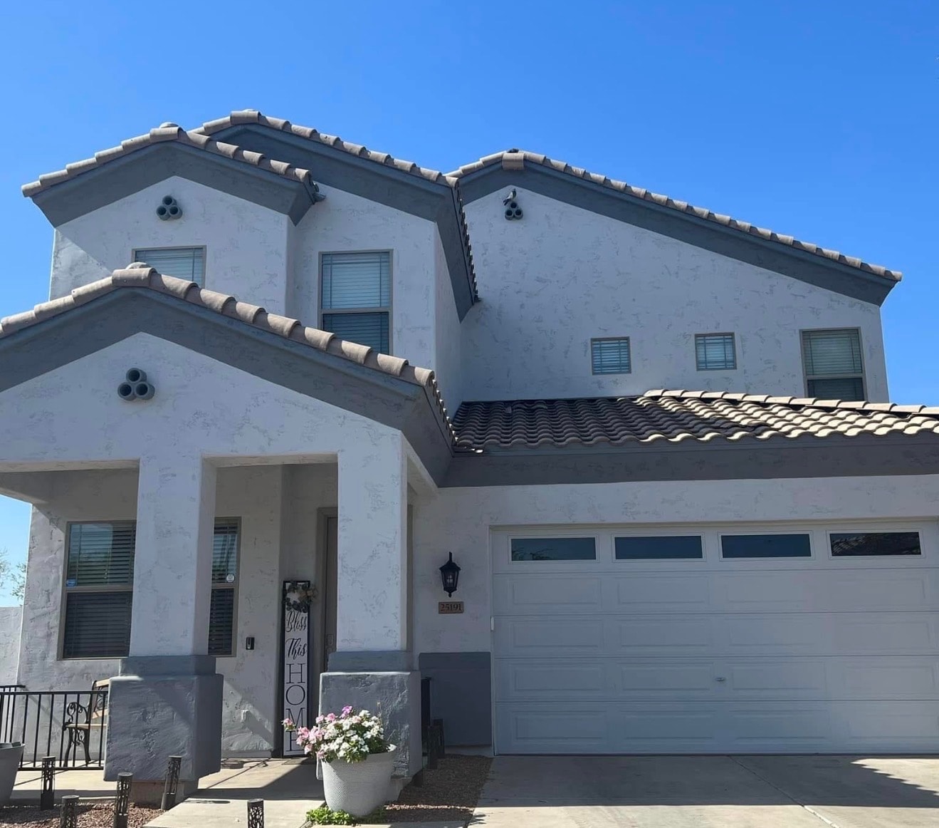 Residential exterior with fresh stucco finish and tile roofing